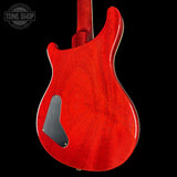 Red electric guitar body on a black background with 'Tone Shop' logo.