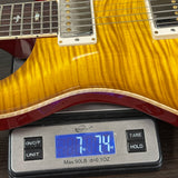 Electric guitar on a digital scale displaying weight