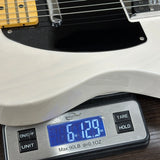 Guitar on a digital scale displaying weight
