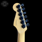 Guitar headstock with tuning pegs on a black background, featuring the Tone Shop logo.