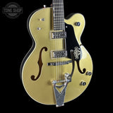 Gold electric guitar with Gretsch logo on a black background