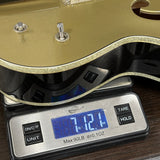 Digital kitchen scale with a gold lid on a wooden surface
