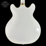 White electric guitar body on a black background with 'Tone Shop' logo.