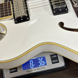 Digital scale displaying weight of a white electric guitar