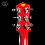 Red guitar headstock with tuning pegs on a black background, featuring 'Tone Shop' logo.