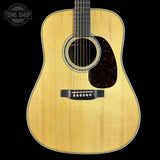 Acoustic guitar with a visible brand logo in the corner