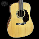 Acoustic guitar with a visible brand logo in the corner