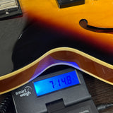Used Epiphone ES-335 Vintage Sunburst on scale displaying weight.
