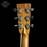 Close-up of a guitar headstock with tuning pegs on a black background, featuring the Tone Shop logo.