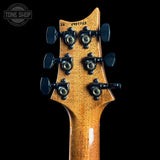 Guitar headstock with tuning pegs on a black background, featuring the Tone Shop logo.