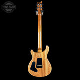 Wooden electric guitar on a black background with 'Tone Shop' logo.