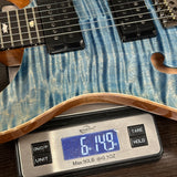 Electric guitar on a digital scale displaying weight
