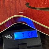 Collings I35-LC Faded Cherry on scale displaying weight.