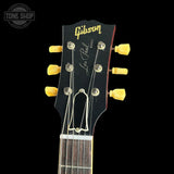 Gibson Les Paul guitar headstock with tuning pegs on a black background