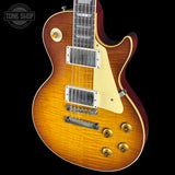 Electric guitar with a sunburst finish on a black background, featuring the Tone Shop logo.