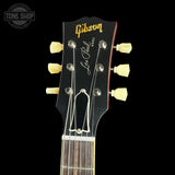 Gibson Les Paul guitar headstock with brand logo on a black background