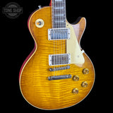 Electric guitar with a sunburst finish on a black background, featuring the Tone Shop logo.