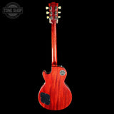 Red electric guitar on a black background with 'Tone Shop' logo.