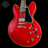 Red electric guitar with a black background