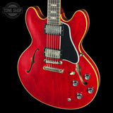 Red electric guitar with a black background