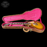 Gibson Les Paul guitar in a pink-lined case with 'Tone Shop' logo.