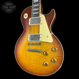 Electric guitar with a sunburst finish on a black background, featuring the Tone Shop logo.