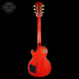 Red electric guitar on a black background with 'Tone Shop' logo.