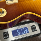 Guitar on a digital scale displaying weight