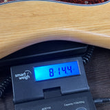 Vintage 1979 Strat Natural on scale displaying weight.