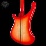 Electric guitar with a sunburst finish on a black background, featuring the Tone Shop logo.