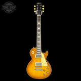 Electric guitar with a sunburst finish on a black background, featuring the Gibson logo.