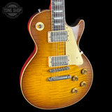 Gibson Les Paul electric guitar with a sunburst finish on a black background, featuring the Tone Shop logo.