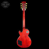 Red electric guitar with a black background, featuring the Tone Shop logo.