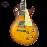Electric guitar with a sunburst finish on a black background, featuring the Tone Shop logo.