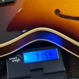 Used Gibson Custom Shop 1964 ES-335 Vintage Burst on scale displaying weight.