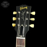 Gibson Les Paul guitar headstock with brand logo on a black background