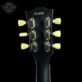 Guitar headstock with tuning pegs on a black background, featuring 'Tone Shop' branding.