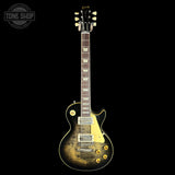 Electric guitar with a sunburst finish on a black background, featuring the Gibson logo.