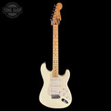 A classic Fender Stratocaster electric guitar in cream finish with a natural maple neck, shown against a solid black background. A 'Tone Shop' watermark is visible in the top-left corner.