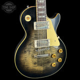Electric guitar with a sunburst finish on a black background, featuring the Tone Shop logo.