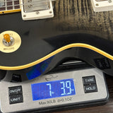 Guitar on a digital scale displaying weight