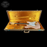 Guitar in a gold case with 'Tone Shop' logo in the corner