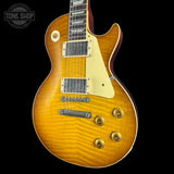 Electric guitar with a sunburst finish on a black background, featuring the Tone Shop logo.