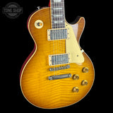 Electric guitar with a sunburst finish on a black background, featuring the Tone Shop logo.