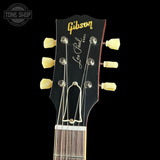 Gibson Les Paul guitar headstock with brand logo on a black background