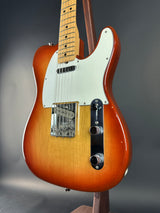 Electric guitar with a sunburst finish on a gray background