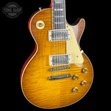 Electric guitar with a sunburst finish on a black background, featuring the Tone Shop logo.