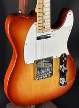 Electric guitar with a sunburst finish on a black background