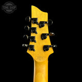 Close-up of the headstock of a guitar with a bright yellow maple finish, black tuning pegs, and a visible Tone Shop watermark in the top left corner.