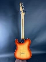 Electric guitar with a sunburst finish on a dark blue background